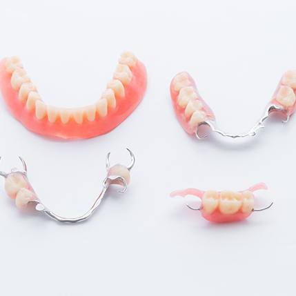 Full and partial dentures on white background